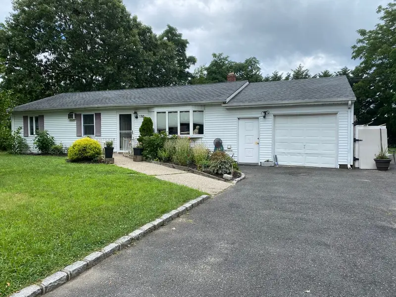 White ranch with a two-car garage and a long driveway, Patchogue, NY